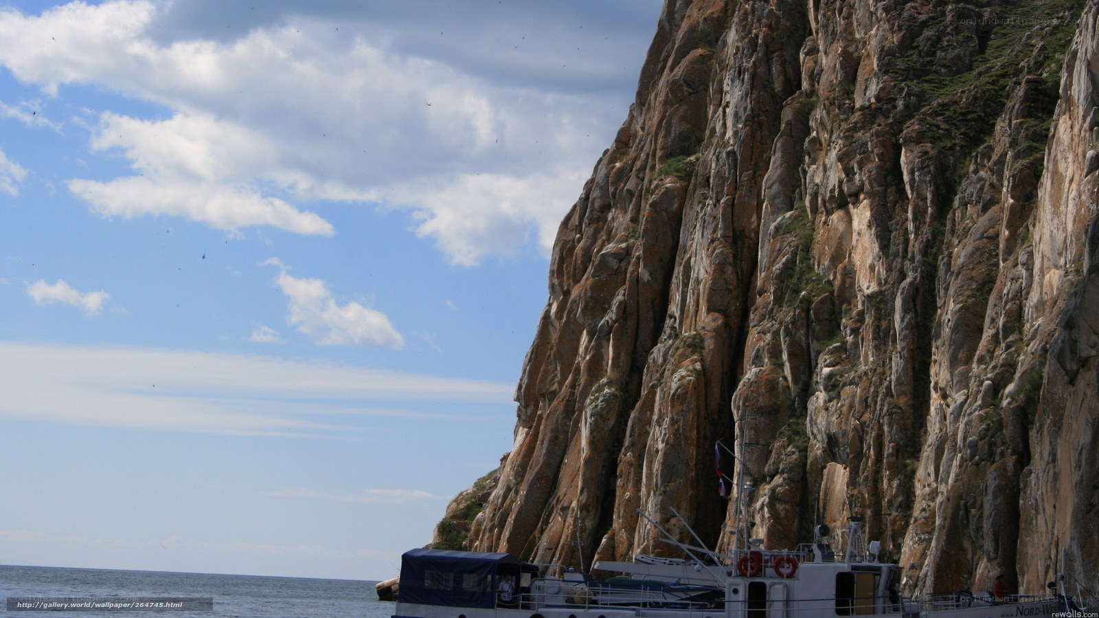 Boat near rocky cliff