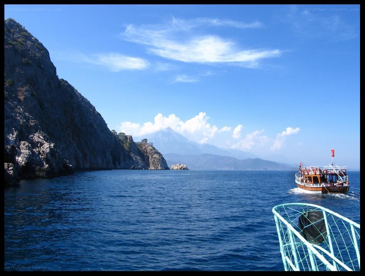 Boat near rocky coastline