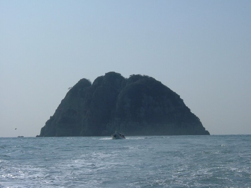 Boat near rocky island