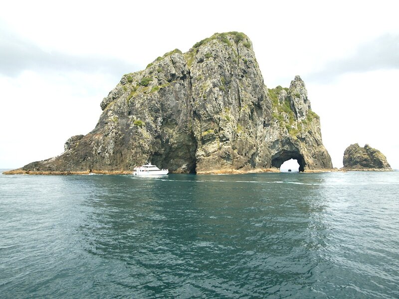 boat near sea arch island