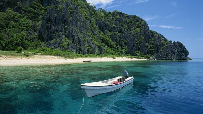 Boat near tropical island shore