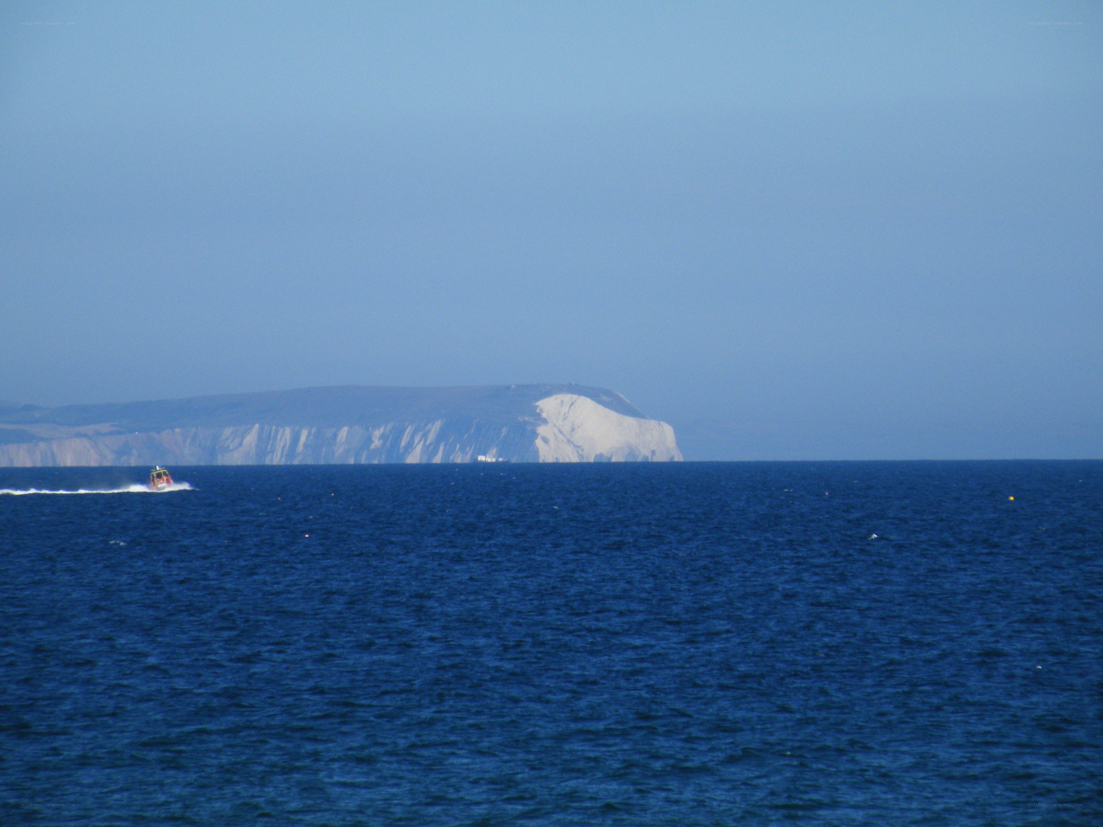 Boat near white cliffs