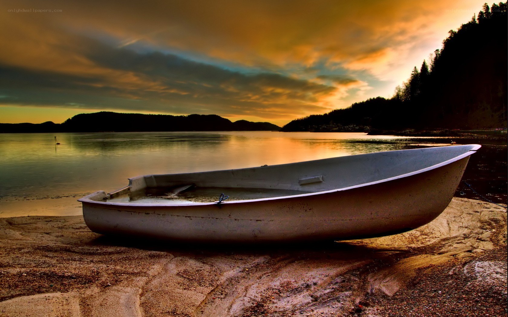 Boat on a beach at sunset