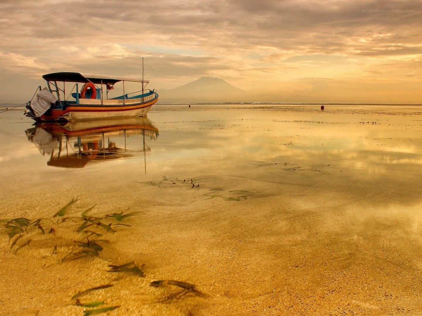 Boat on a beach at sunset