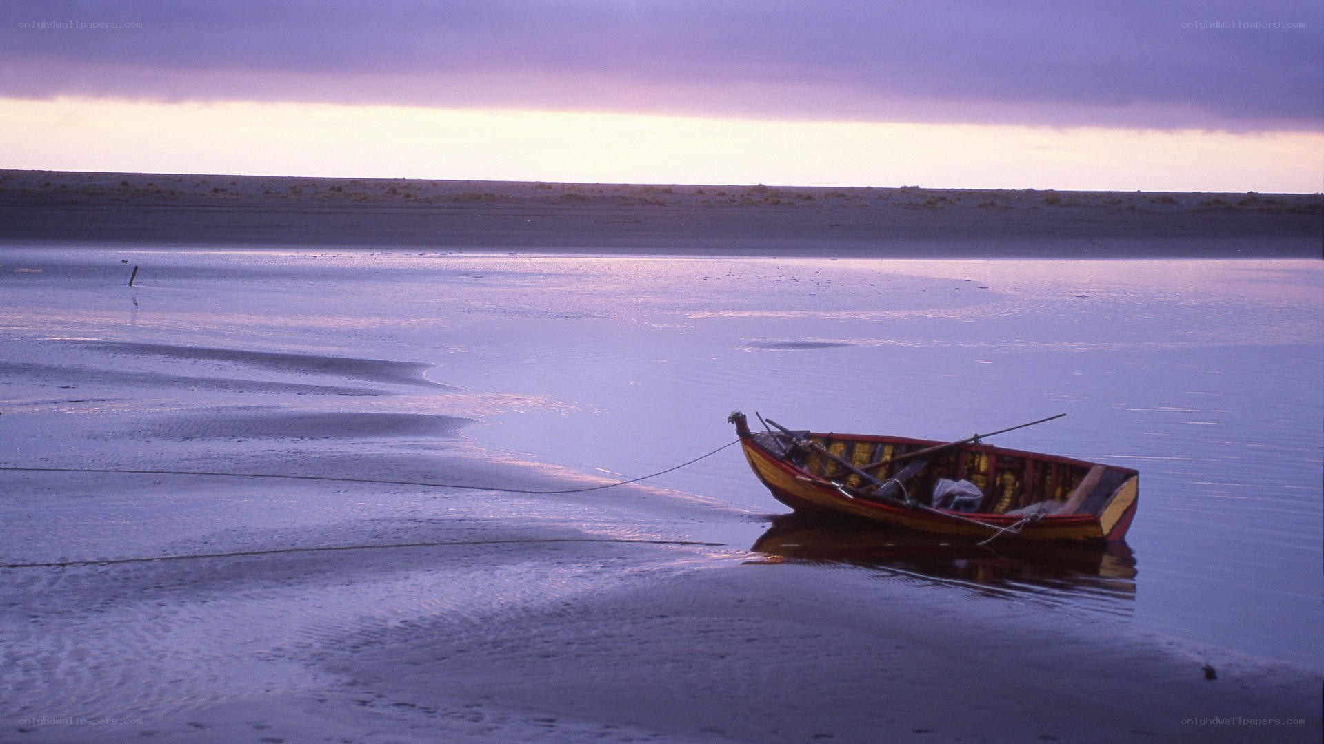Boat on a calm beach at dusk