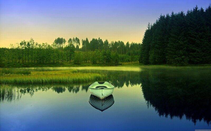Boat on a calm lake at dawn