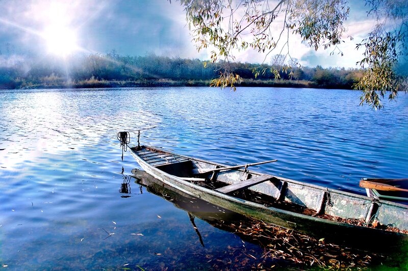 Boat on a calm lake at sunrise