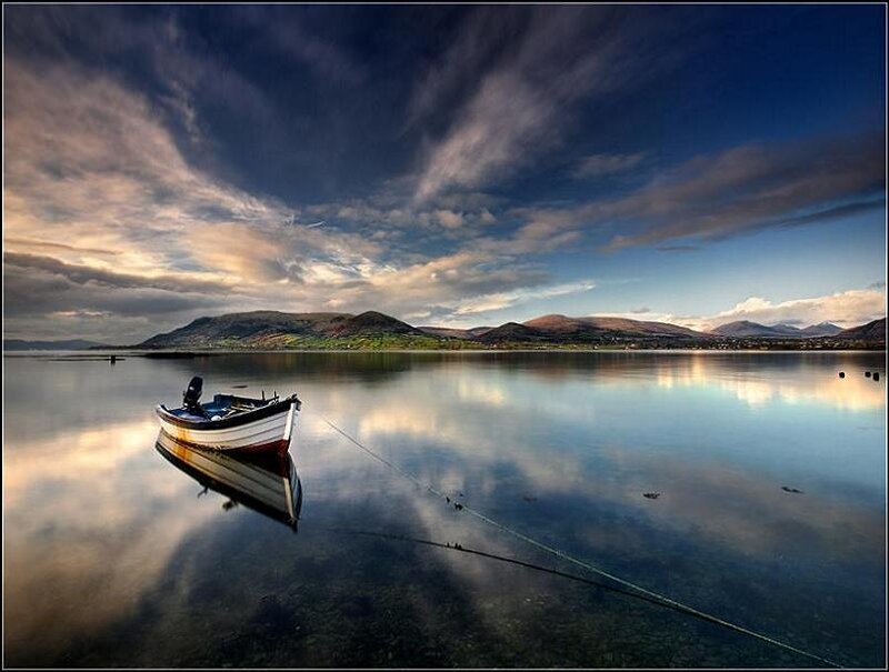 Boat on a calm lake at sunset