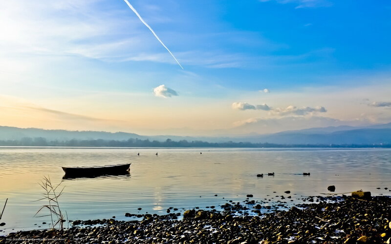Boat on a calm lake at sunset