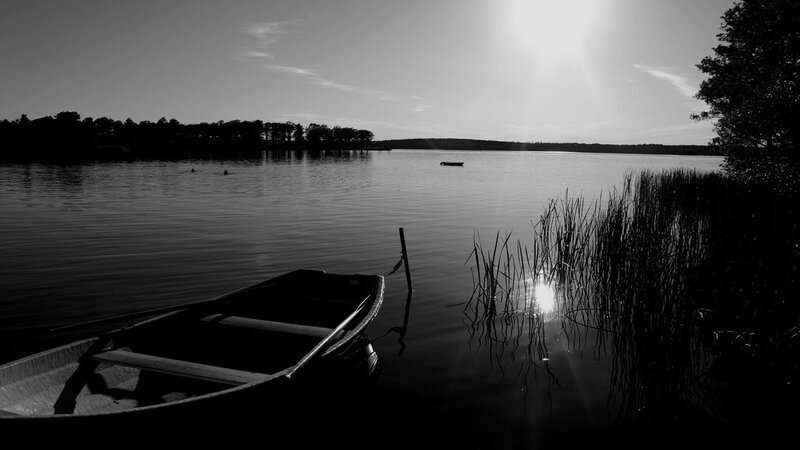Boat on a calm lake at sunset