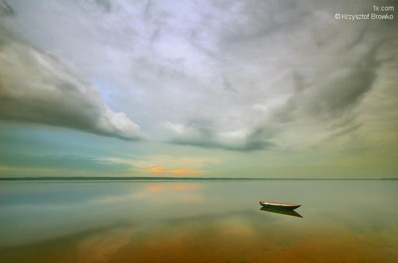 Boat on a calm lake at sunset