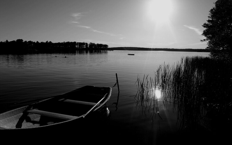 Boat on a calm lake at sunset
