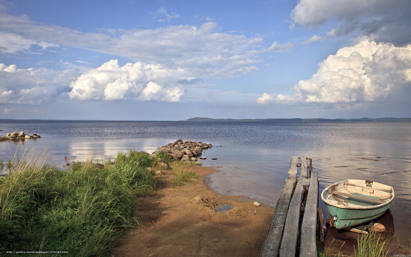 Boat on a calm lake shore