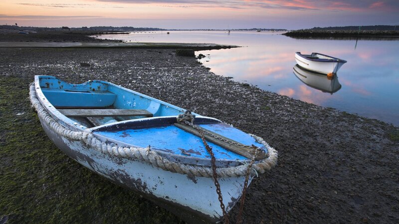 Boat on a calm shore at sunset
