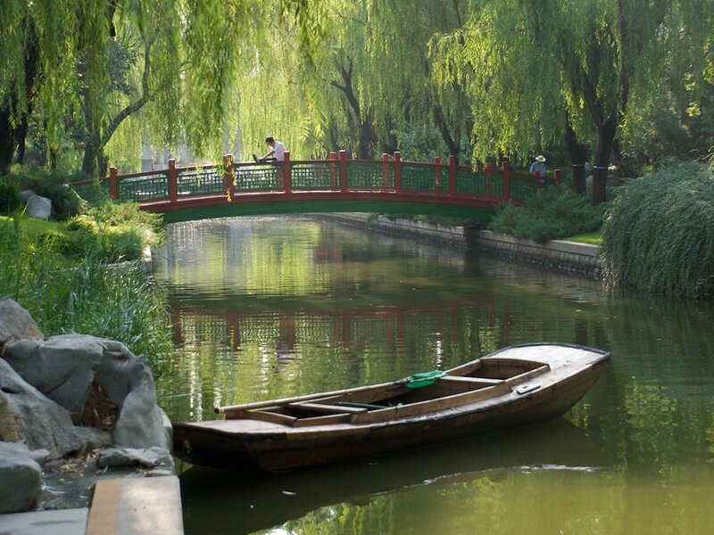 Boat on a canal under a bridge