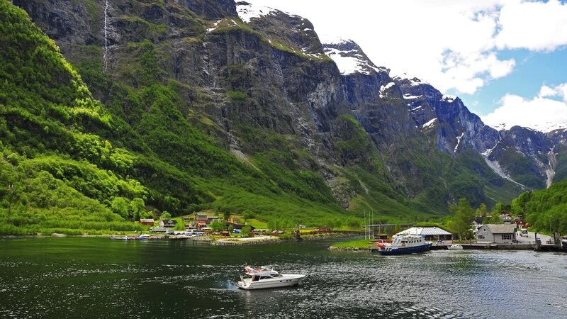 Boat on a fjord with mountains