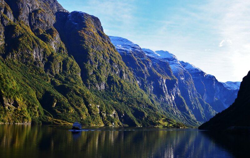 boat on a fjord with mountains