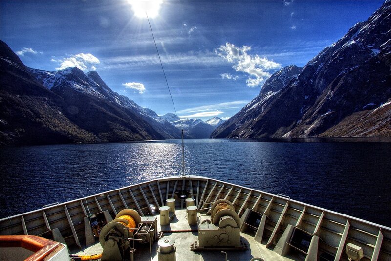 Boat on a fjord with mountains