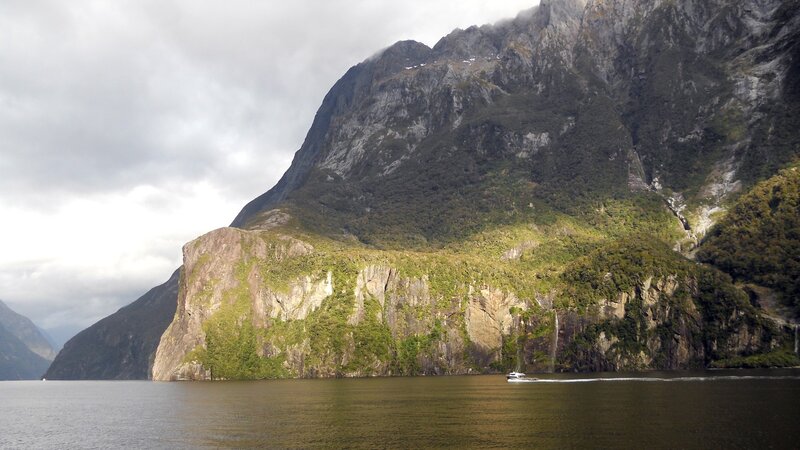 boat on a fjord with mountains