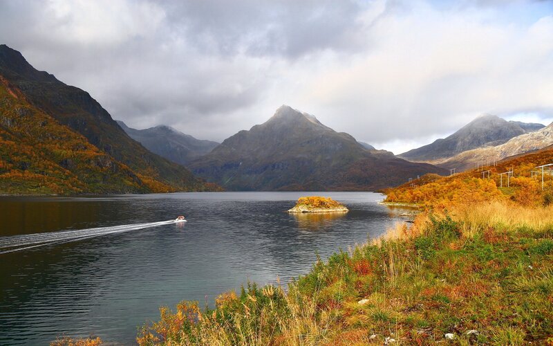 Boat on a lake in autumn mountains