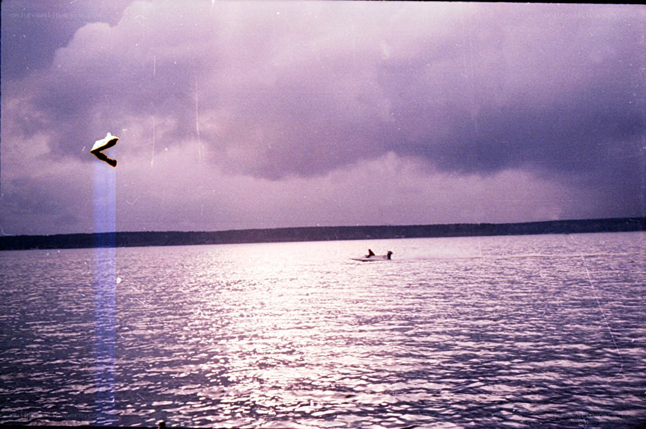 Boat on a lake under cloudy sky