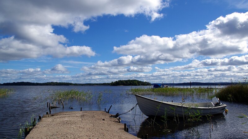 Boat on a lake with clouds