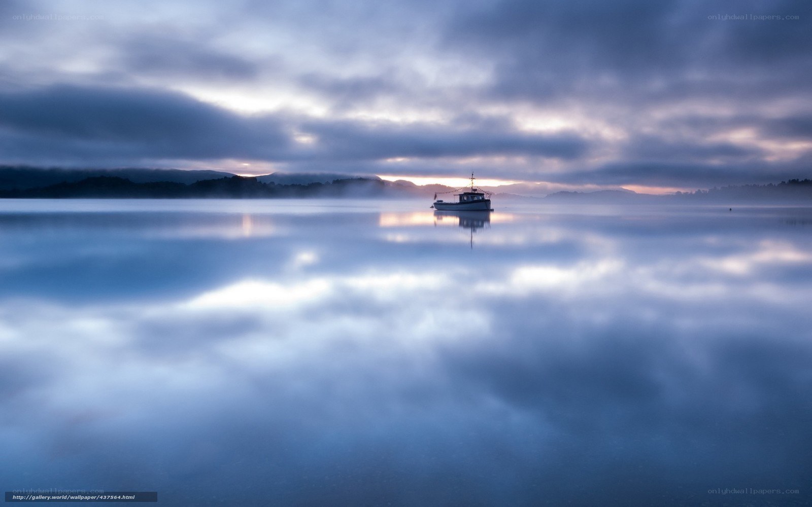 Boat on a misty lake at dawn