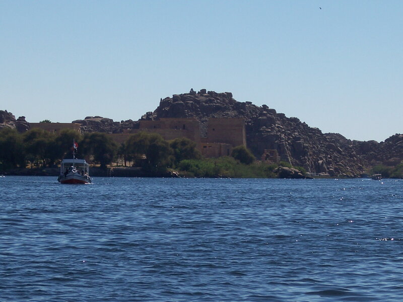 Boat on a river near ancient ruins
