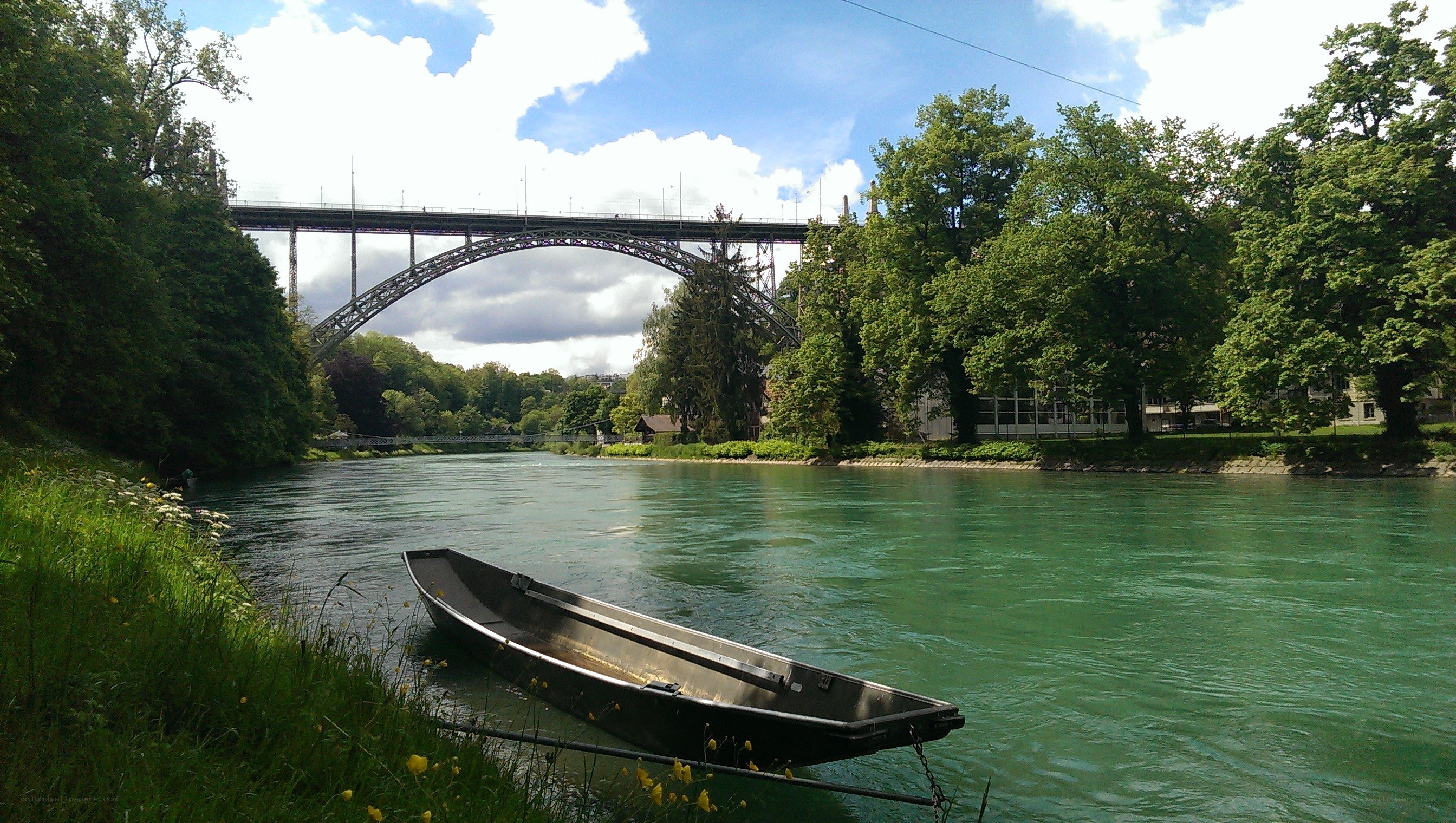 Boat on a river under a bridge