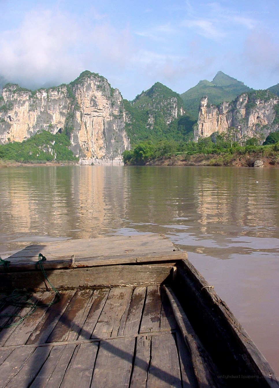 Boat on a river with karst mountains