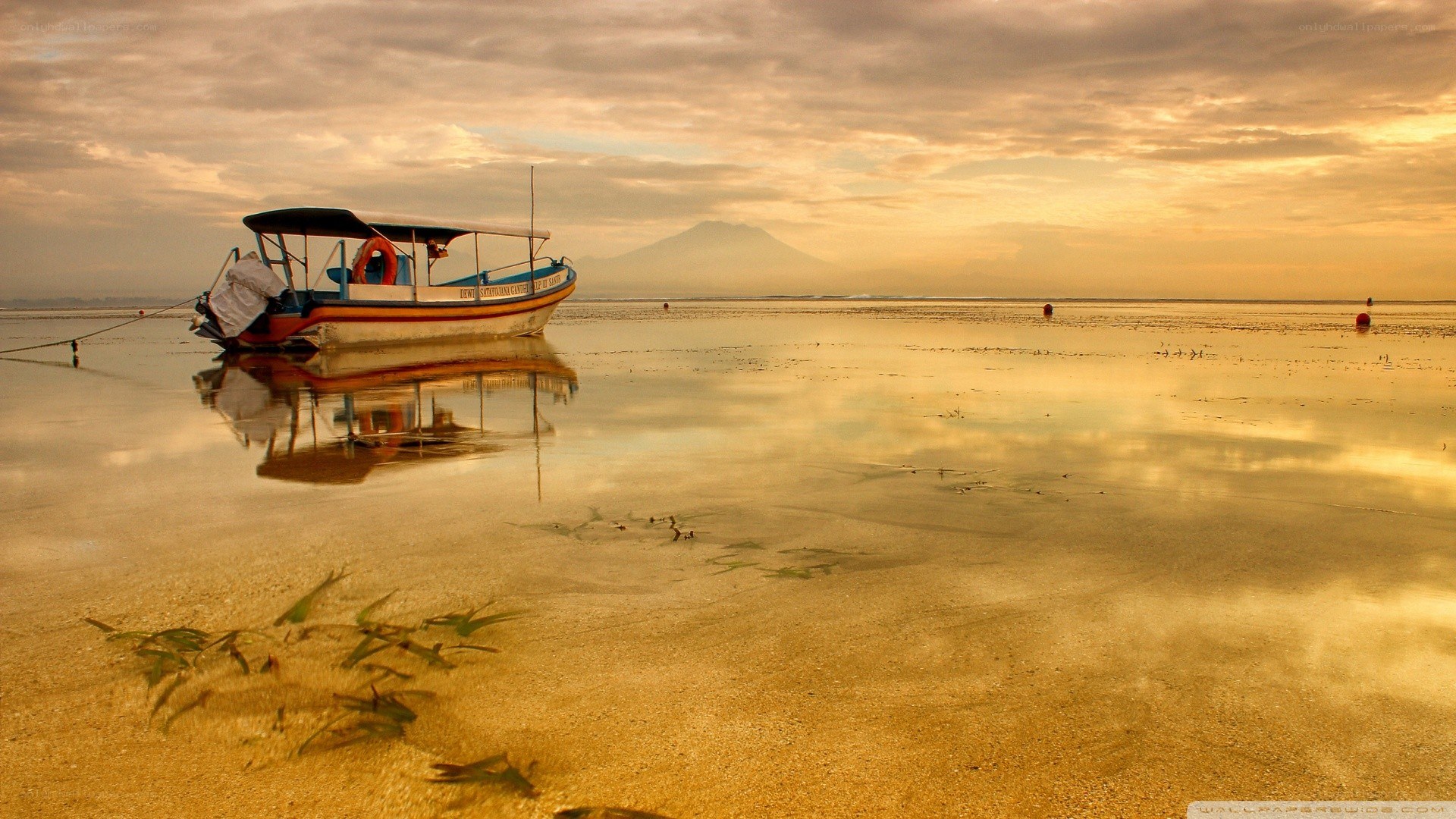 Boat on beach at sunset