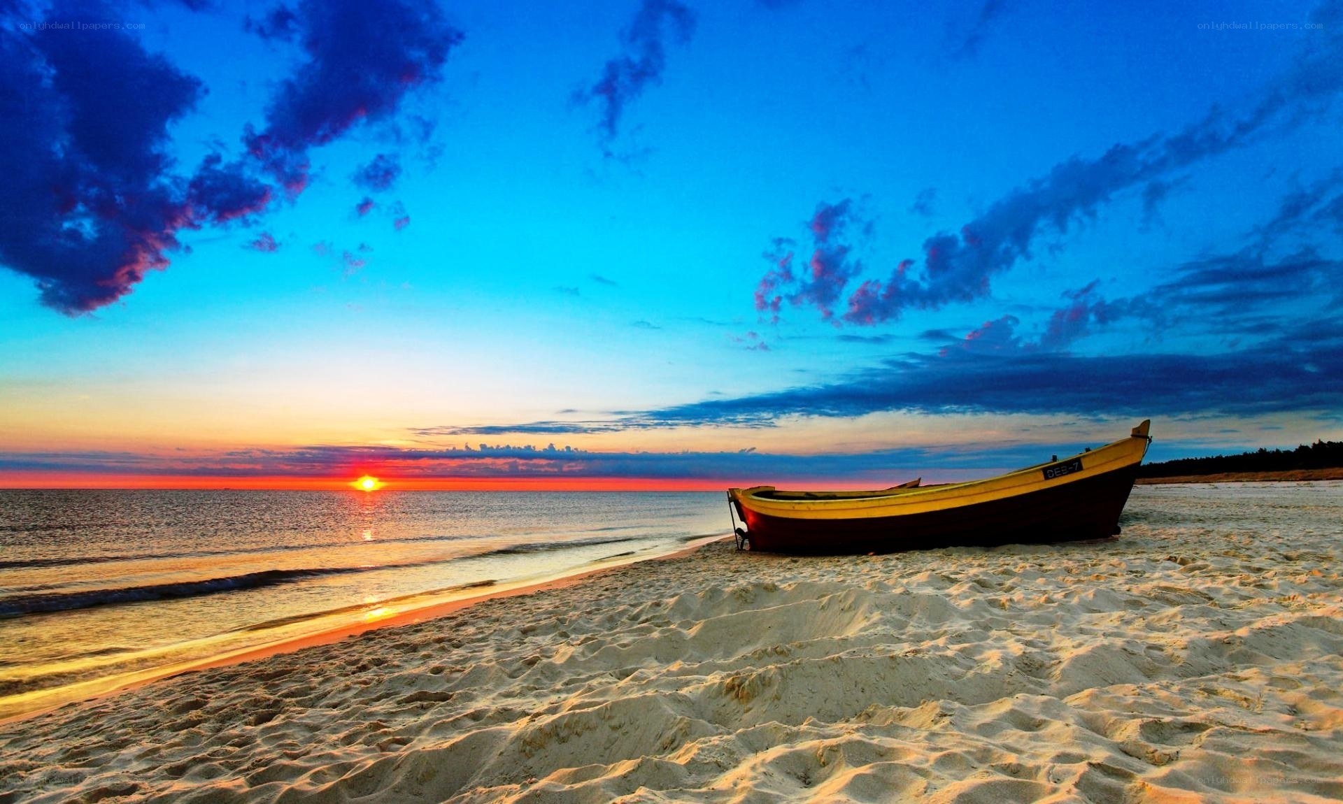 Boat on beach at sunset