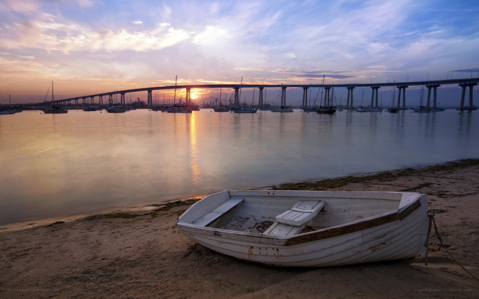 Boat on beach at sunset