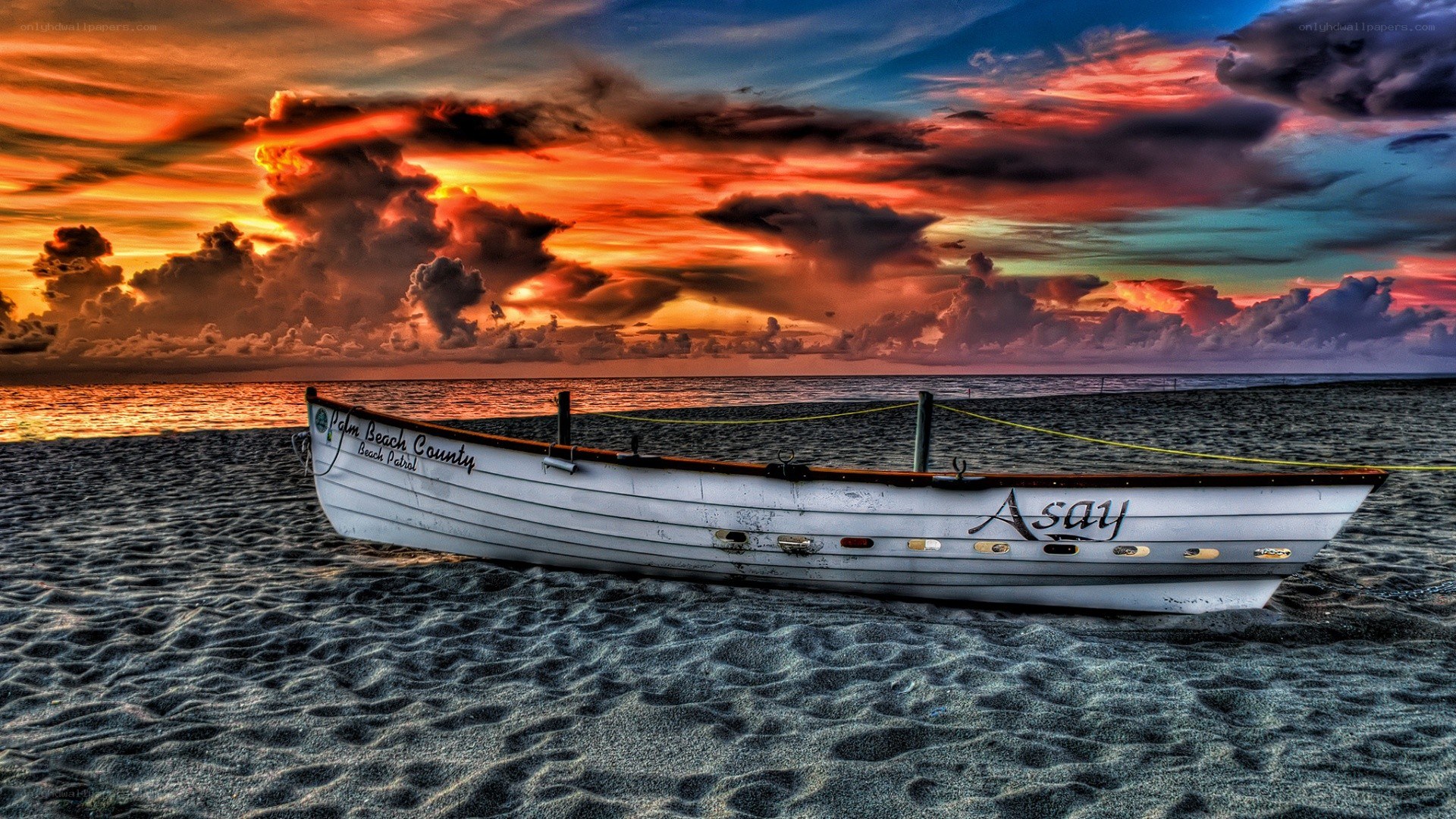 Boat on beach at sunset
