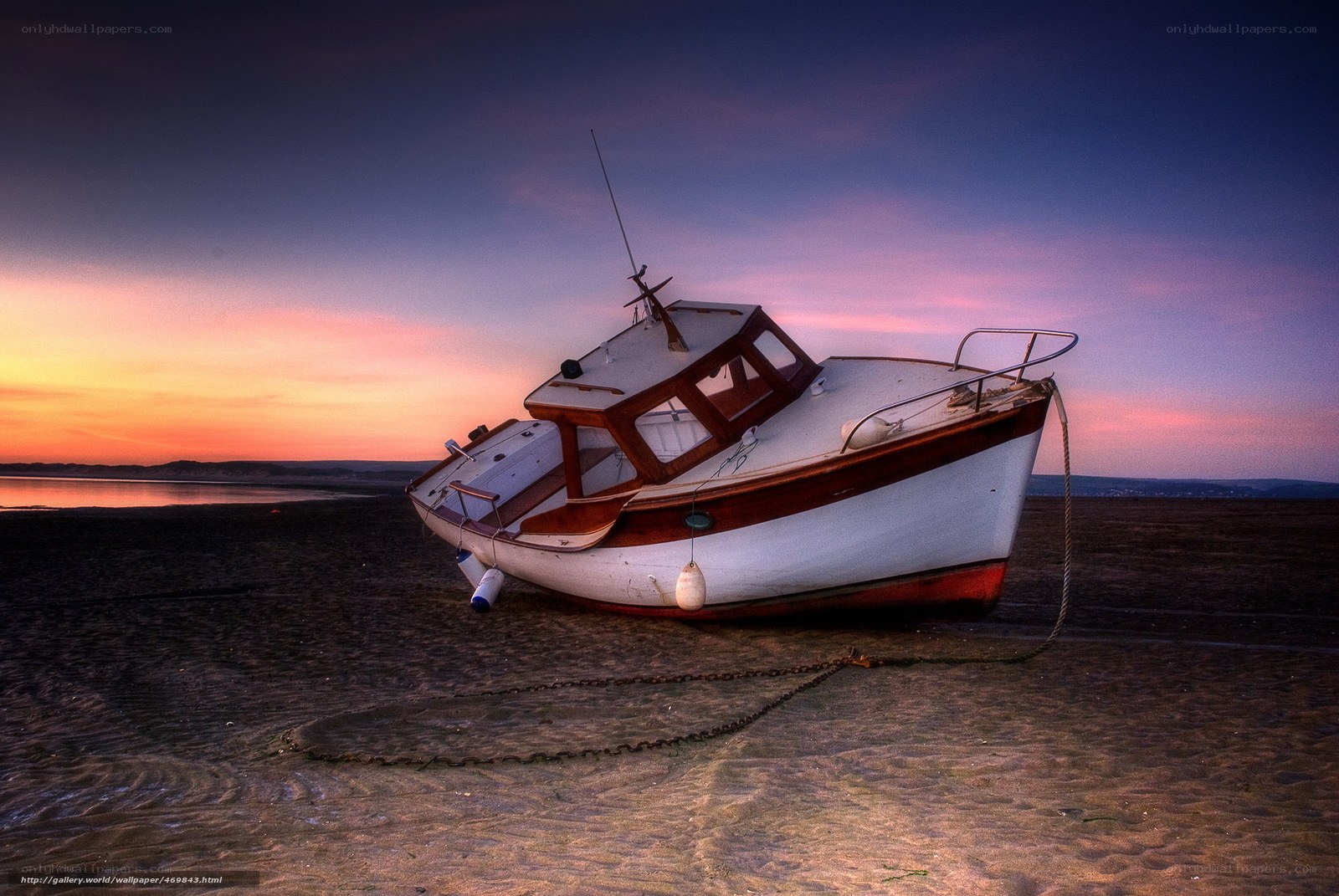 boat on beach at sunset