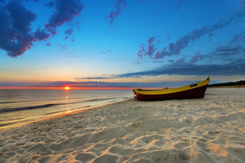 Boat on beach at sunset