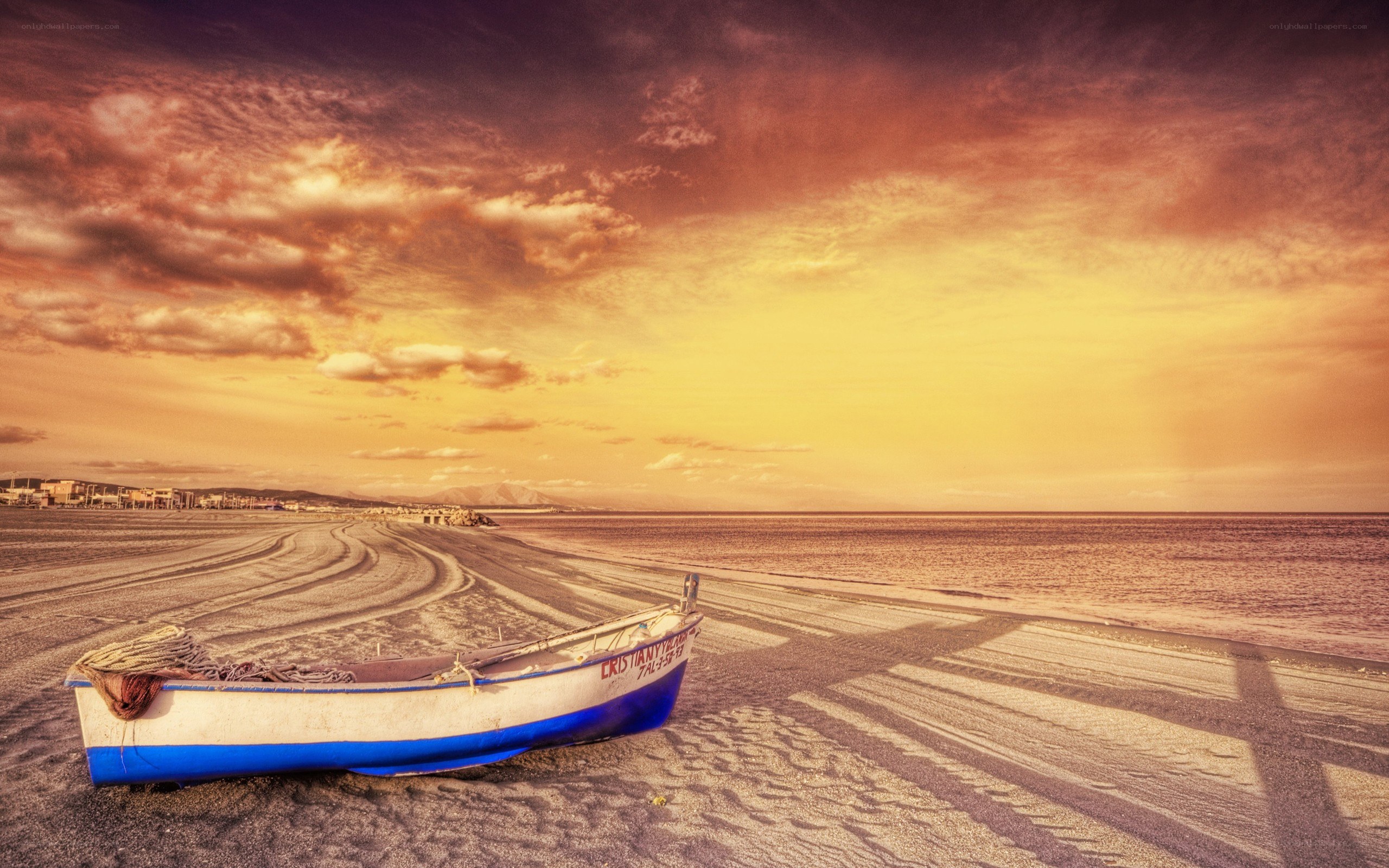 Boat on beach at sunset