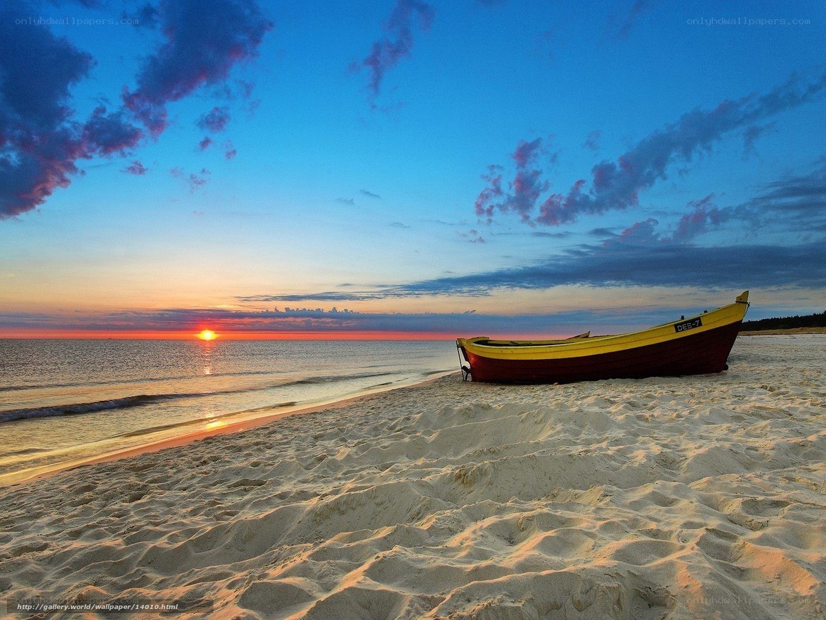Boat on beach at sunset