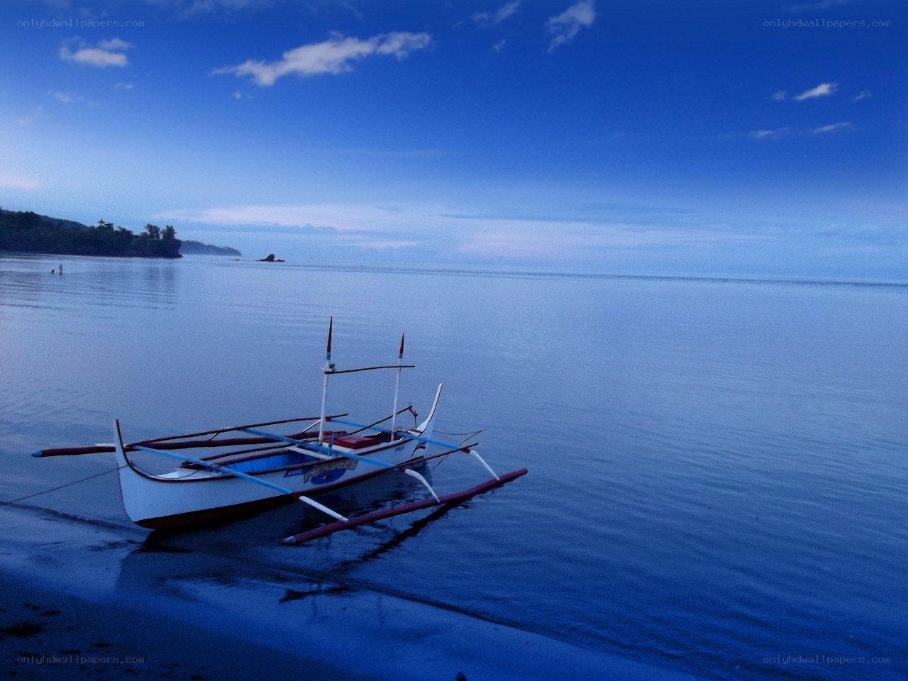 Boat on calm beach at dusk