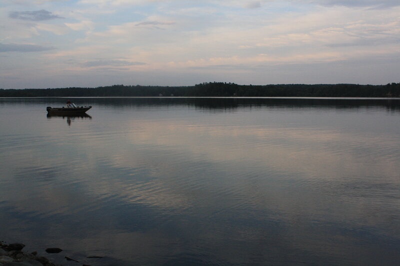 Boat on calm lake at dusk