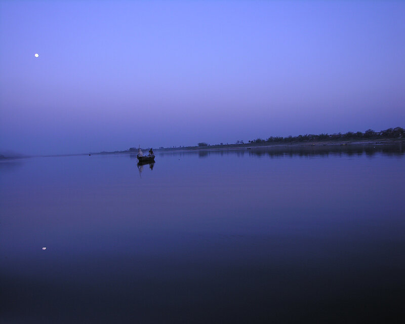 Boat on calm river at dusk