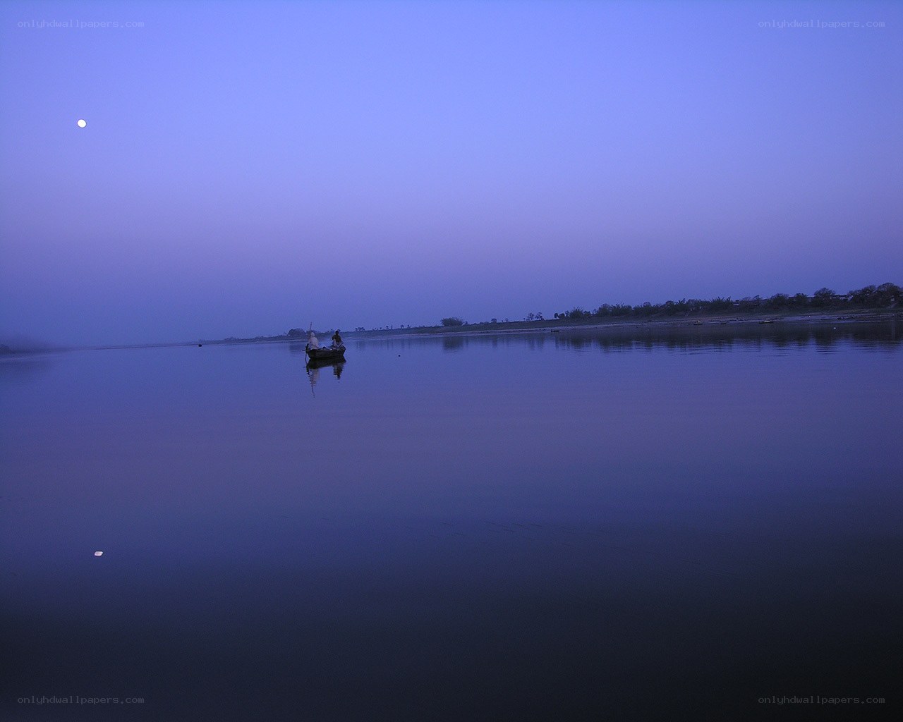 Boat on calm river at dusk