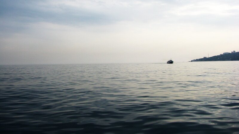 boat on calm sea at dusk