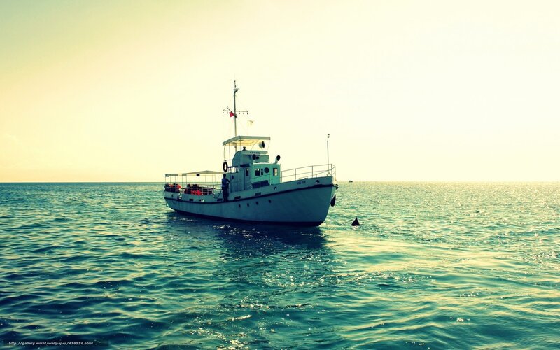 Boat on calm sea at sunset