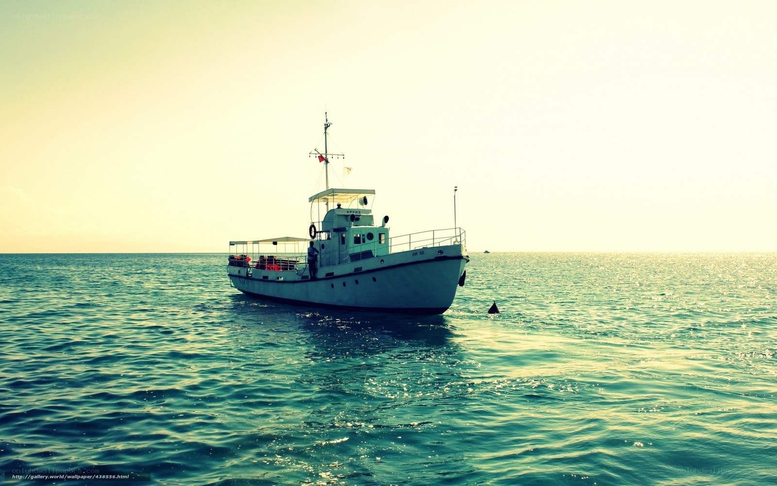 Boat on calm sea at sunset