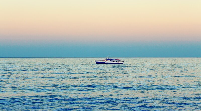 Boat on Calm Sea — Blue, Serene, Sunset