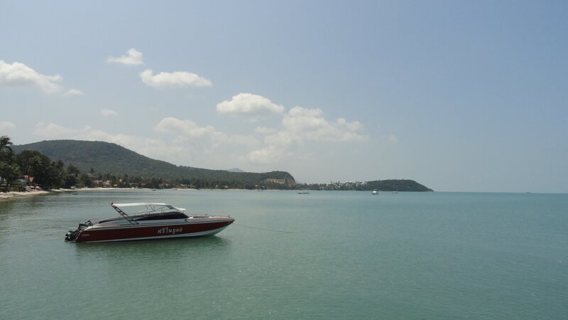 Boat on calm sea near island