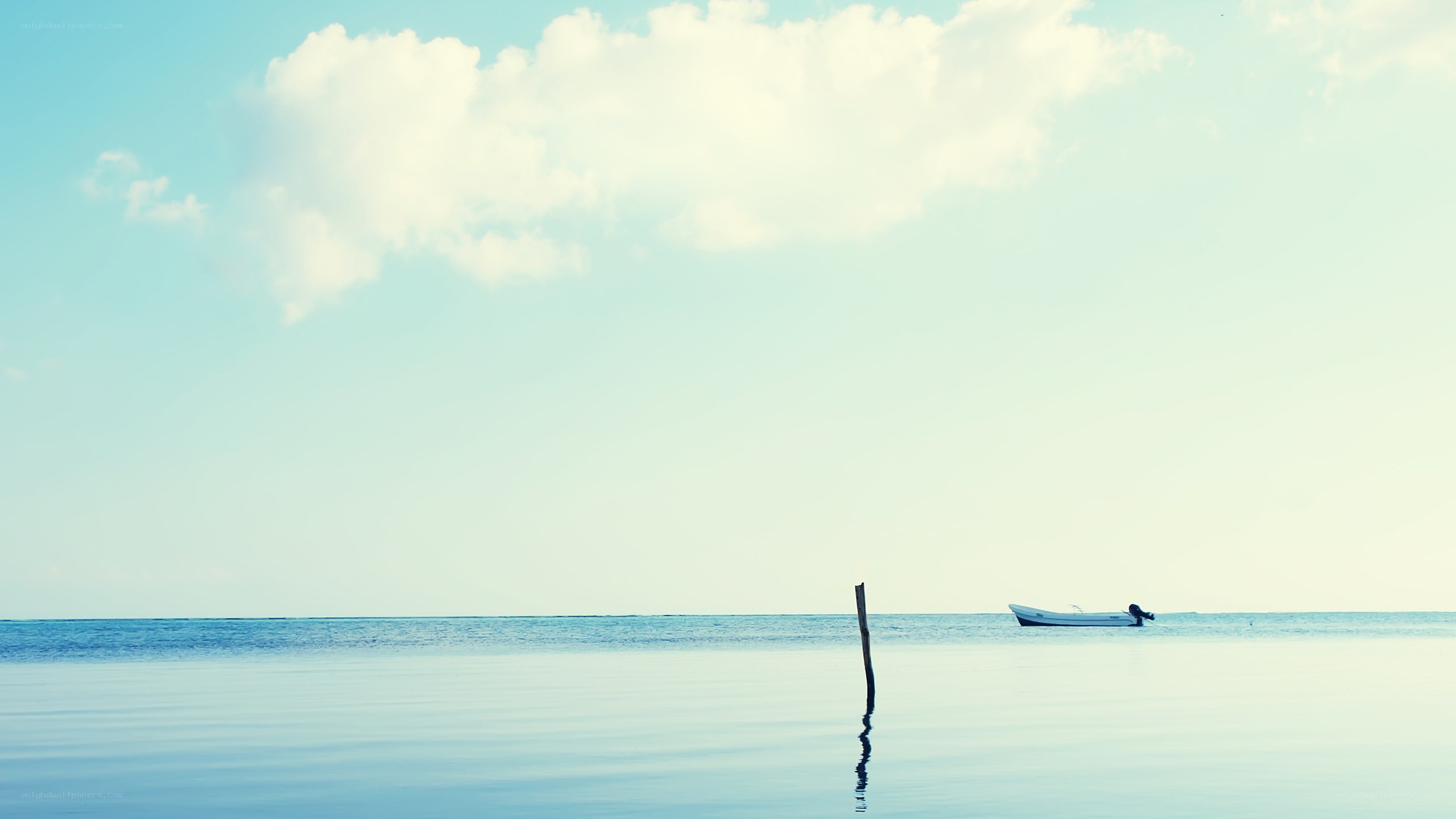 Boat on calm sea with cloud
