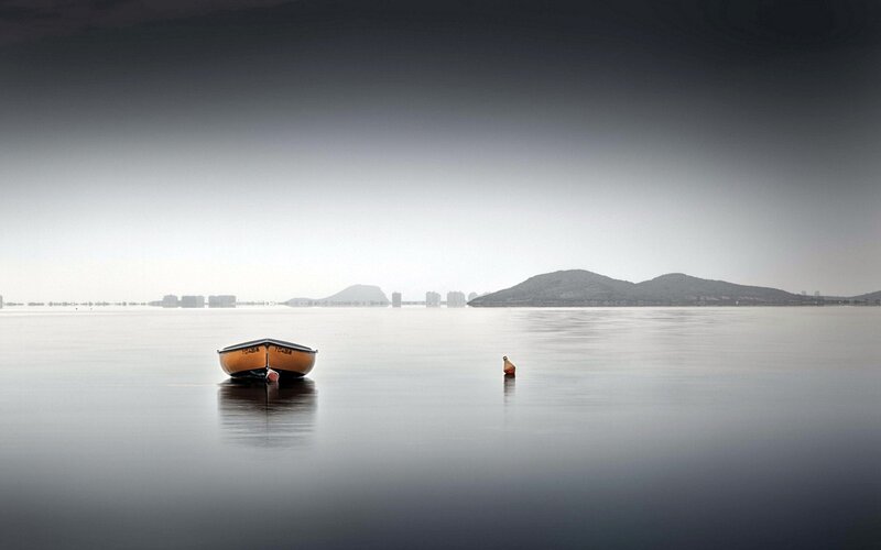 Boat on calm water at dawn