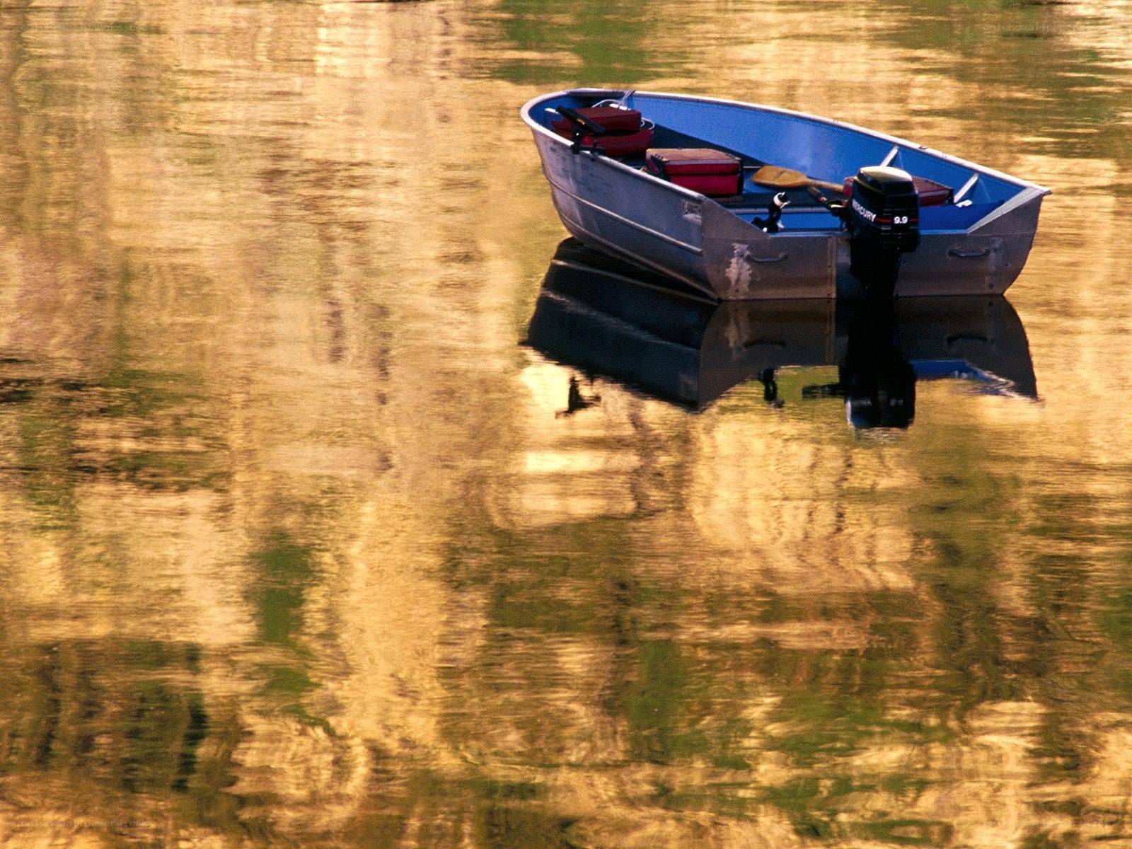 Boat on calm water at sunset